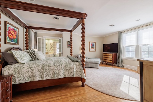 bedroom featuring ornamental molding and hardwood / wood-style floors