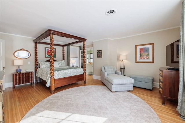 bedroom with crown molding and wood-type flooring