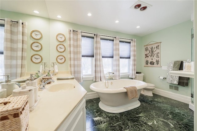 bathroom with a bathing tub, vanity, and toilet