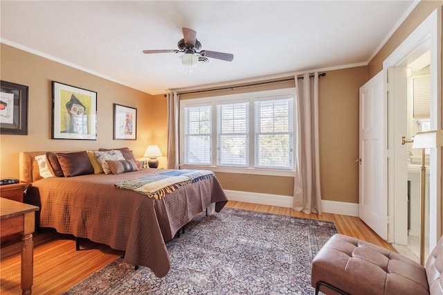 bedroom with ceiling fan, ornamental molding, and light hardwood / wood-style floors