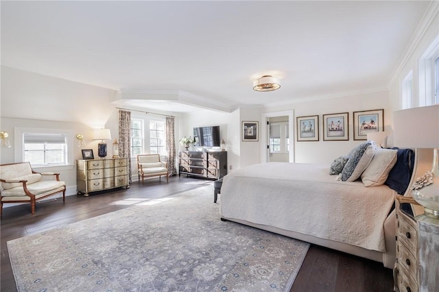 bedroom with ornamental molding and dark hardwood / wood-style floors