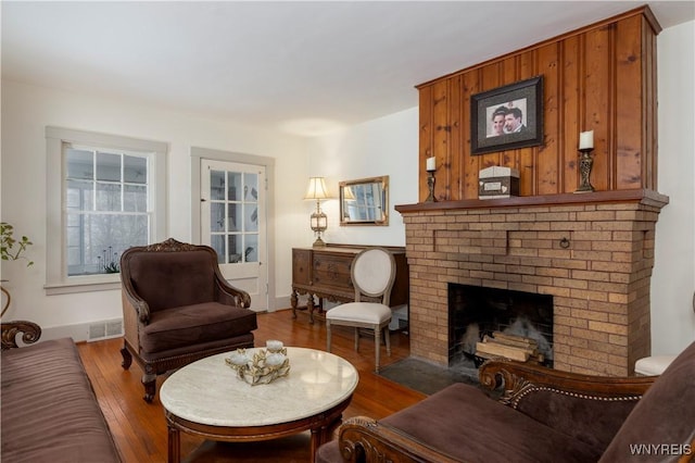 living room with wood-type flooring and a fireplace