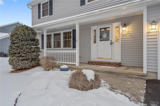 view of snow covered property entrance