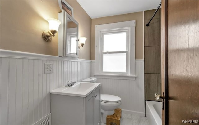 full bathroom featuring vanity, toilet, and  shower combination