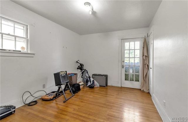 workout area with light hardwood / wood-style flooring