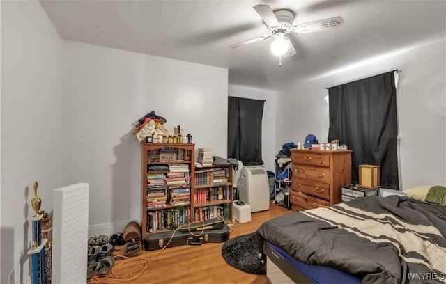 bedroom featuring hardwood / wood-style flooring and ceiling fan