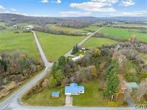 birds eye view of property with a rural view