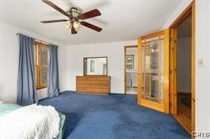 bedroom with ceiling fan and dark carpet