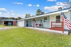 back of property with a garage and a yard