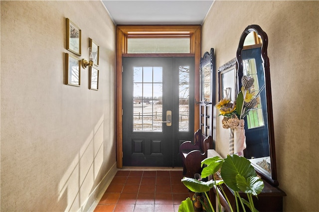 doorway with dark tile patterned floors