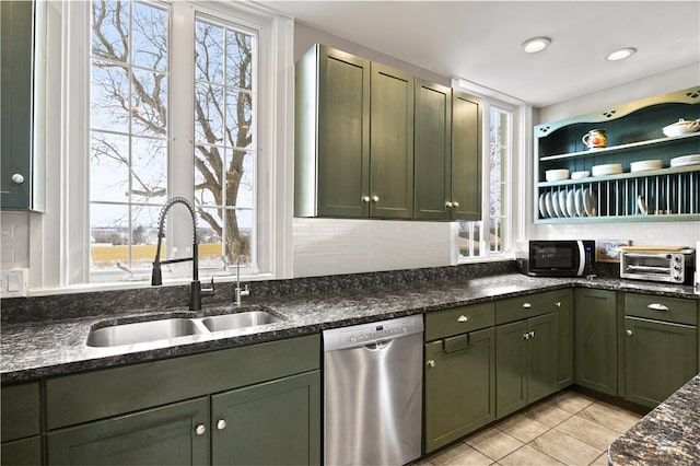 kitchen featuring tasteful backsplash, stainless steel dishwasher, and sink