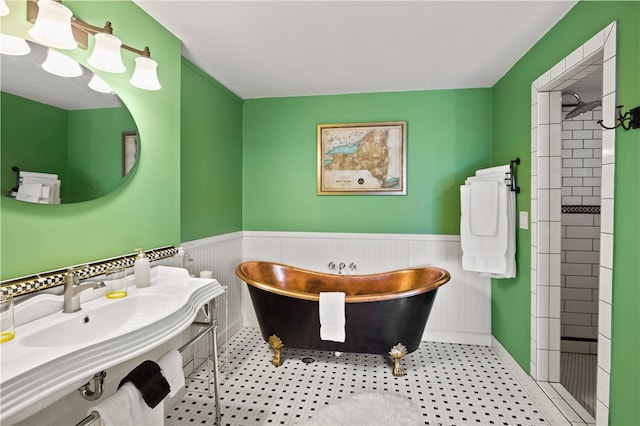 bathroom featuring a bath, tile patterned floors, and sink