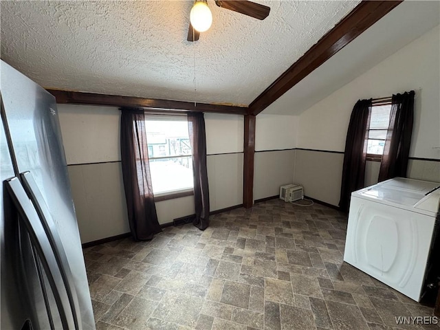 unfurnished dining area featuring ceiling fan, lofted ceiling, and a textured ceiling