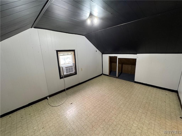 bonus room featuring cooling unit, wooden ceiling, vaulted ceiling, and wood walls