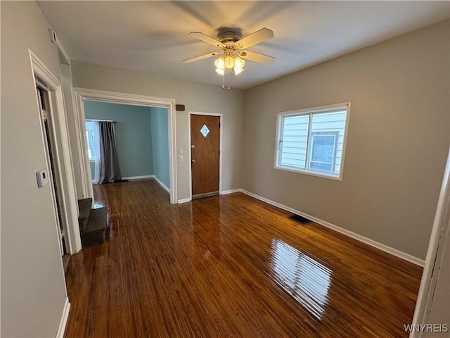 entryway with dark wood-type flooring and ceiling fan