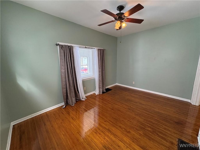 empty room featuring dark hardwood / wood-style floors and ceiling fan