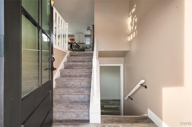 stairs featuring hardwood / wood-style flooring