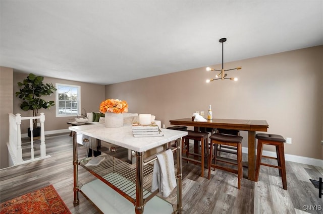 dining room featuring a notable chandelier and wood-type flooring