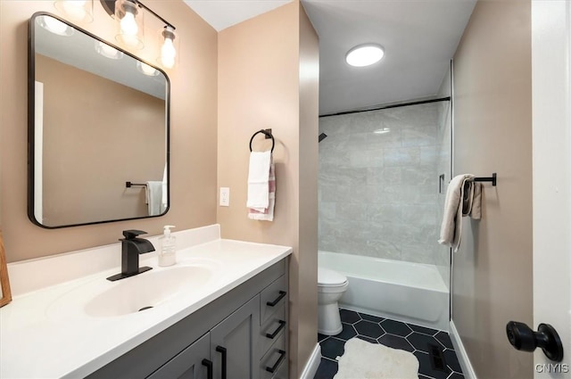 full bathroom with vanity, tiled shower / bath combo, and toilet