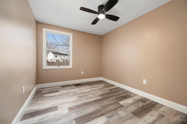 unfurnished room with light hardwood / wood-style flooring and ceiling fan