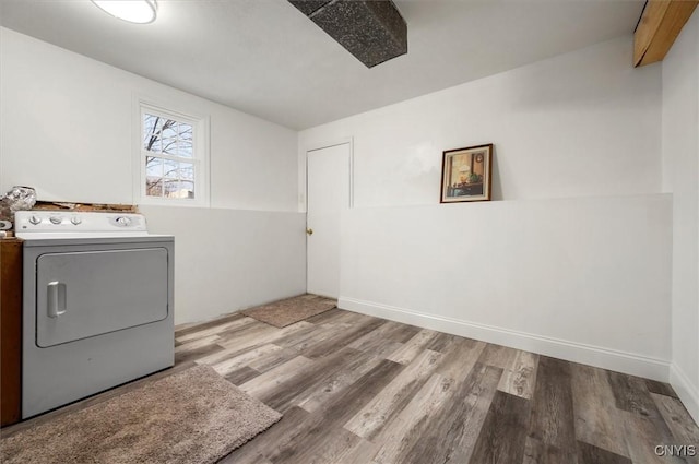 clothes washing area with washer / dryer and light hardwood / wood-style floors