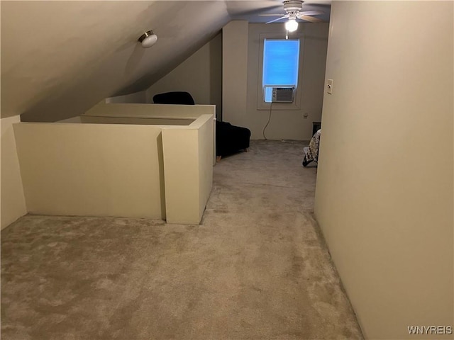 additional living space with cooling unit, light colored carpet, ceiling fan, and vaulted ceiling