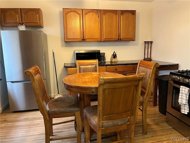 kitchen featuring stainless steel appliances and light hardwood / wood-style floors