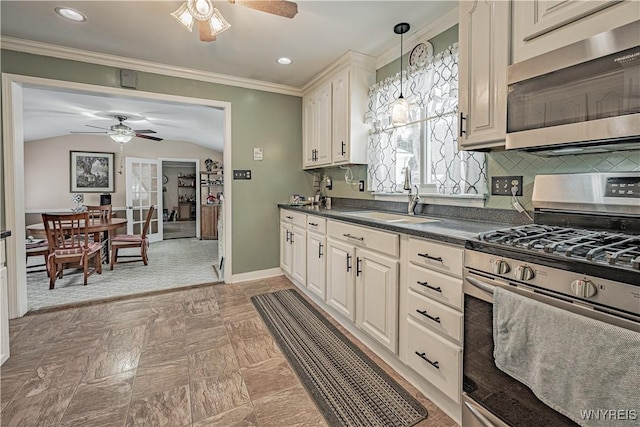 kitchen featuring sink, vaulted ceiling, ceiling fan, and appliances with stainless steel finishes