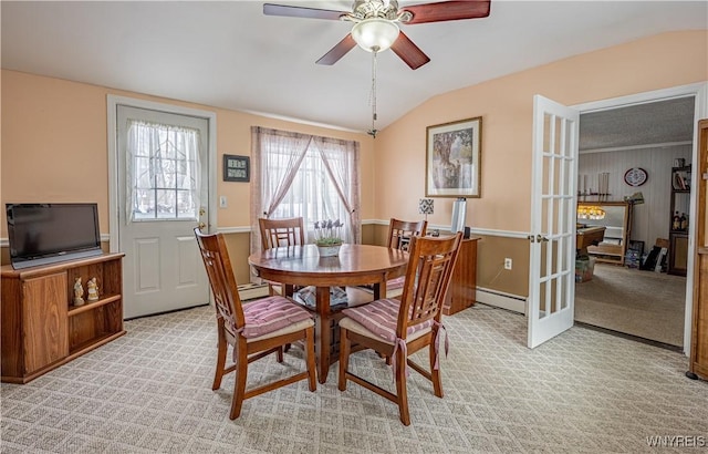 dining room featuring ceiling fan, a baseboard heating unit, vaulted ceiling, light colored carpet, and french doors