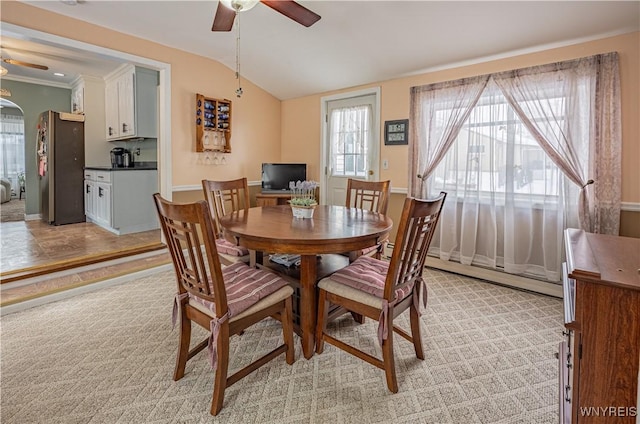 dining area with a baseboard radiator, lofted ceiling, and ceiling fan