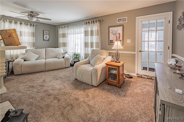 living room featuring carpet flooring and ceiling fan