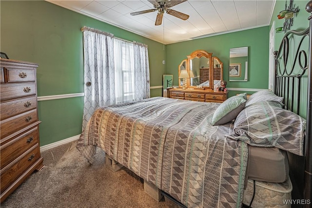 bedroom with crown molding, ceiling fan, and carpet