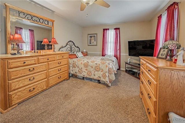 bedroom featuring ceiling fan and carpet