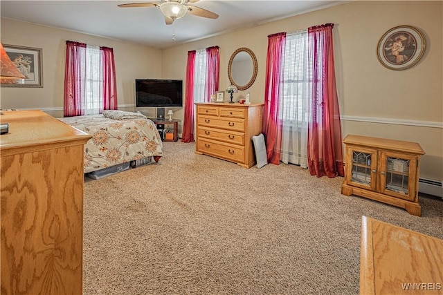 bedroom featuring a baseboard radiator, ceiling fan, and carpet