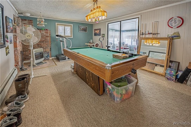 game room with heating unit, a wood stove, ornamental molding, light carpet, and a textured ceiling