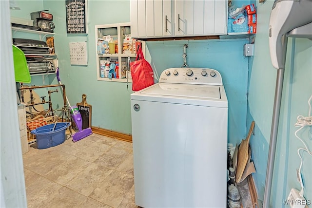 laundry room with cabinets and washer / dryer