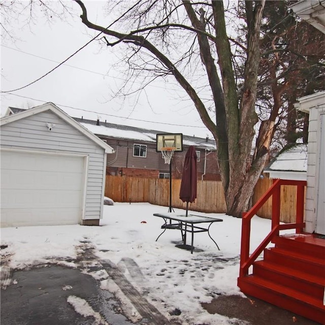 exterior space with a garage and an outbuilding