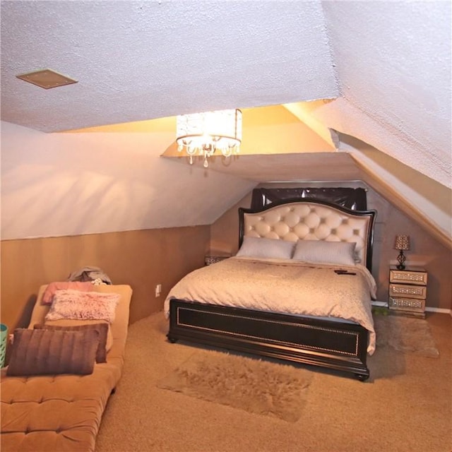 bedroom featuring carpet, lofted ceiling, and a textured ceiling