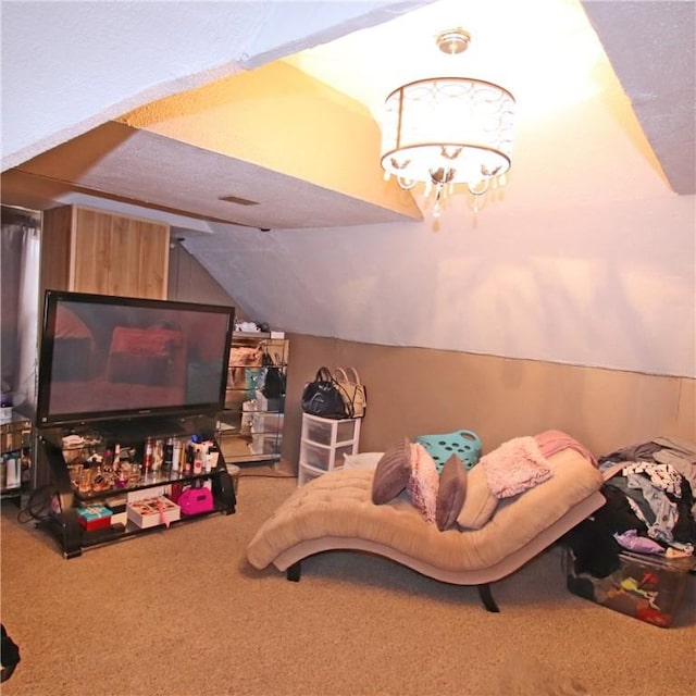 bedroom featuring an inviting chandelier, vaulted ceiling, and carpet