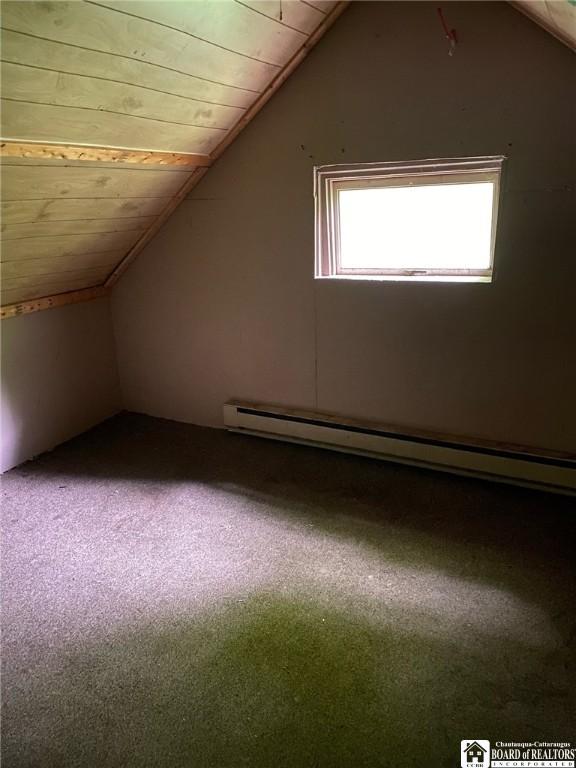 bonus room featuring lofted ceiling, a baseboard heating unit, wood ceiling, and carpet