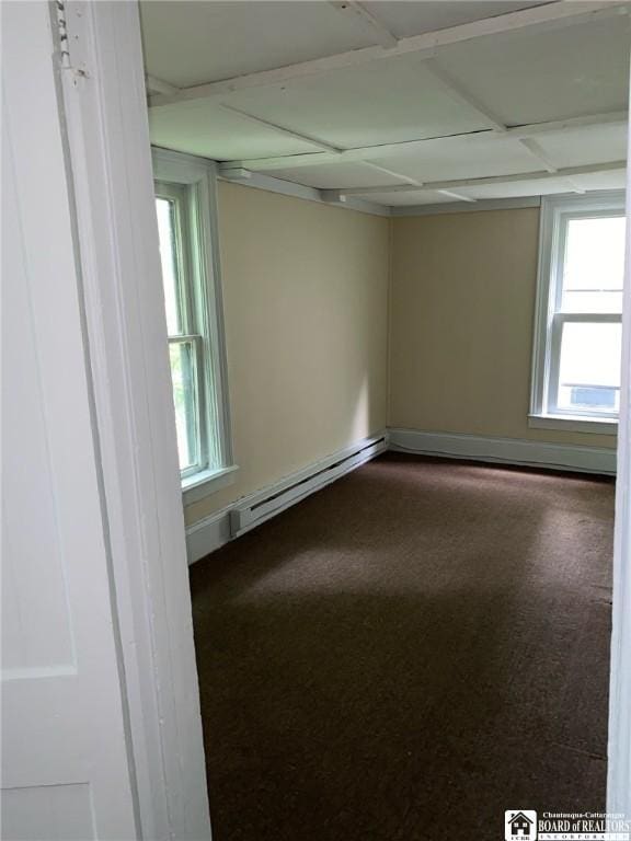 unfurnished room with a baseboard heating unit