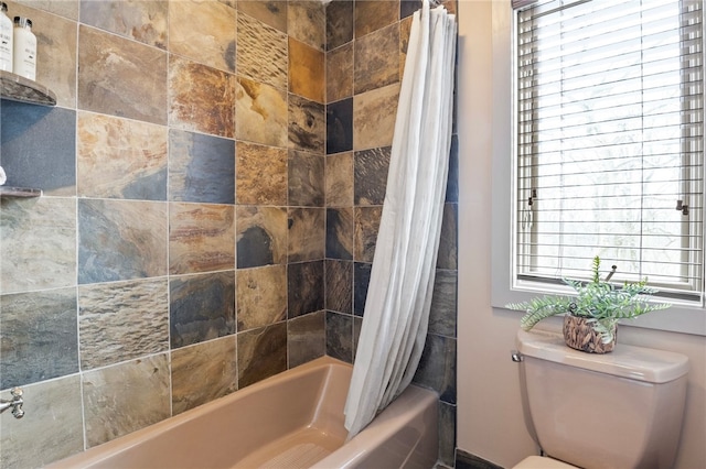 bathroom featuring toilet and shower / tub combo