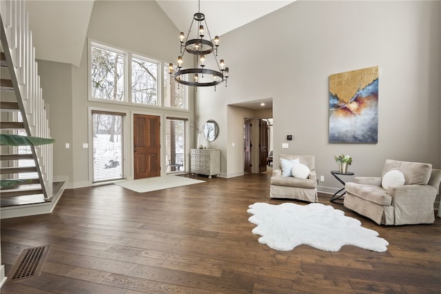 entryway featuring vaulted ceiling, dark hardwood / wood-style floors, and an inviting chandelier