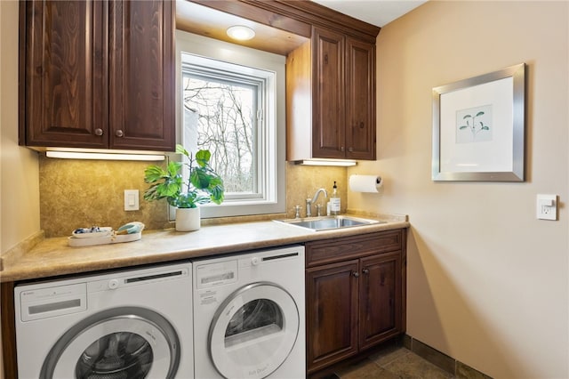 laundry area featuring cabinets, sink, and washing machine and clothes dryer