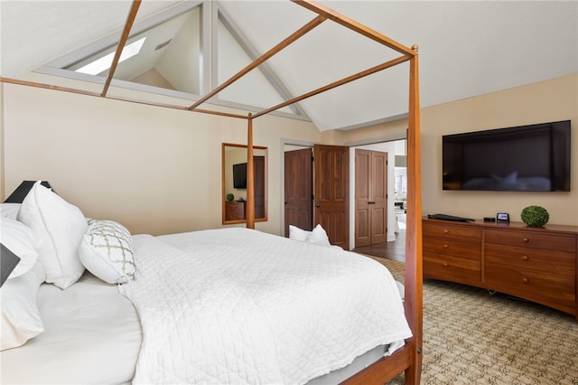 carpeted bedroom with vaulted ceiling