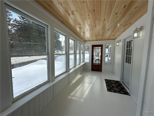 unfurnished sunroom with wood ceiling