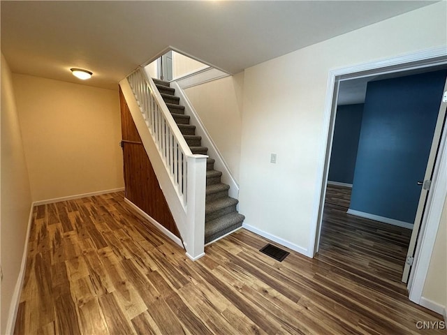 stairs with hardwood / wood-style flooring