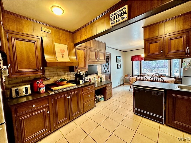 kitchen featuring built in desk, light tile patterned floors, ornamental molding, black dishwasher, and backsplash