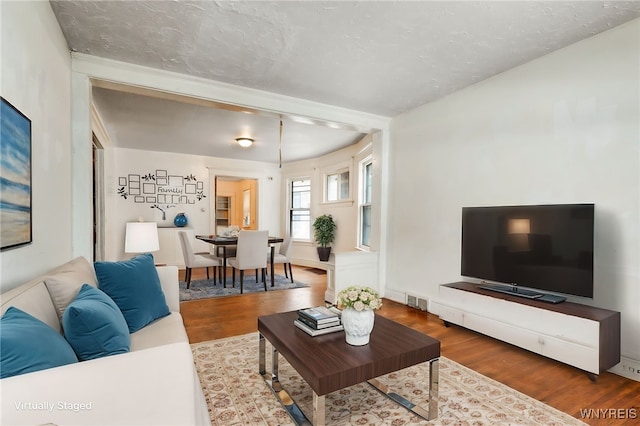 living room with hardwood / wood-style flooring and a textured ceiling