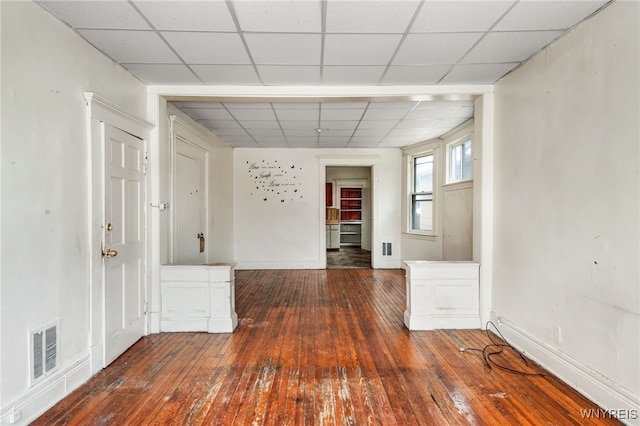 corridor featuring dark hardwood / wood-style floors and a drop ceiling